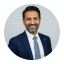 Smiling man in a navy suit and tie, Avenix expert