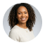 Smiling woman with curly hair, Avenix expert