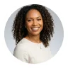 Smiling woman with curly hair from the Avenix contact team
